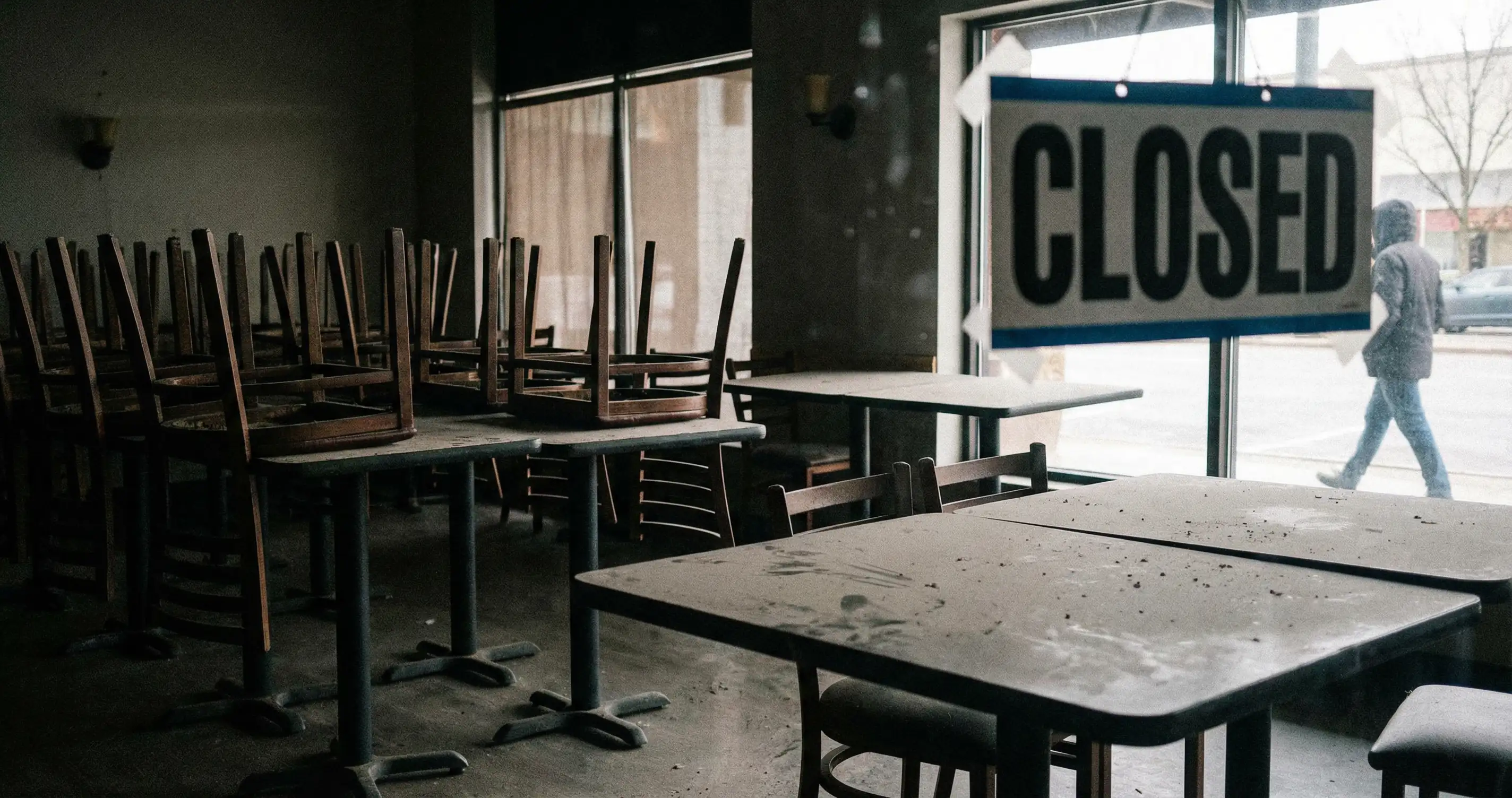Empty restaurant interior, business closures, editorial news style